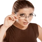 lady pulling down her glasses while looking quizzically at you