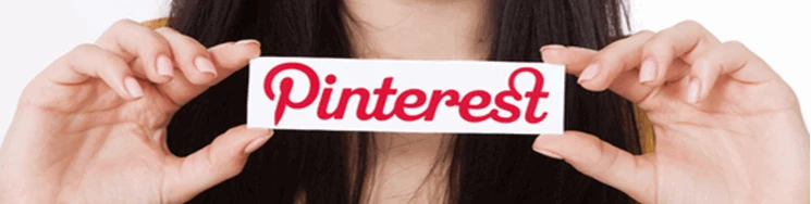 closeup of a lady holding a signe with Pinterest on it